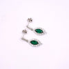 A pair of silver-toned drop earrings with marquise-cut green gemstones surrounded by small clear stones, displayed on a plain white background.