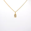 A delicate gold chain necklace with a small rectangular bezel-set clear gemstone pendant, shown against a plain white background.