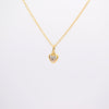 A delicate gold chain necklace with a small heart-shaped pendant set with clear gemstones, displayed against a clean white background.